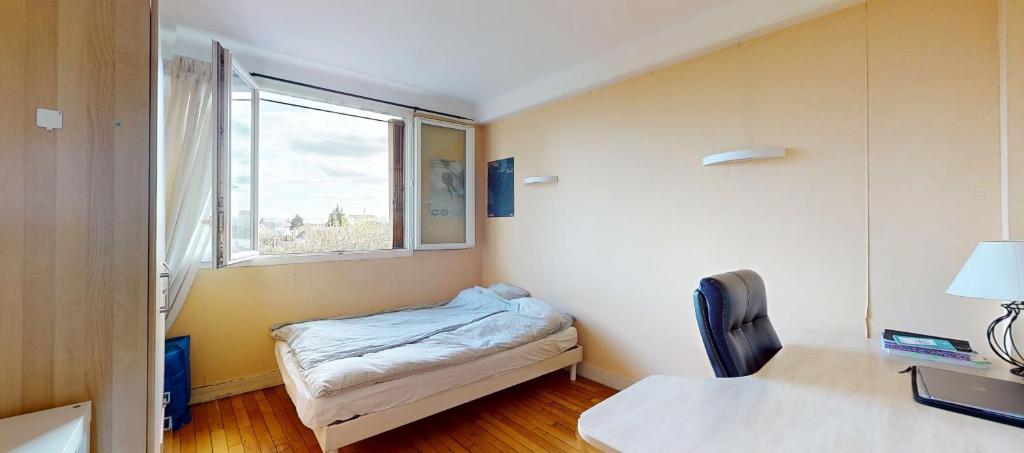 En eller flere senge i et værelse på Appartement 3 pieces à Houilles