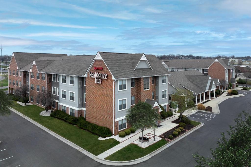 an image of a apartment building with a parking lot at Residence Inn Kansas City Overland Park in Overland Park