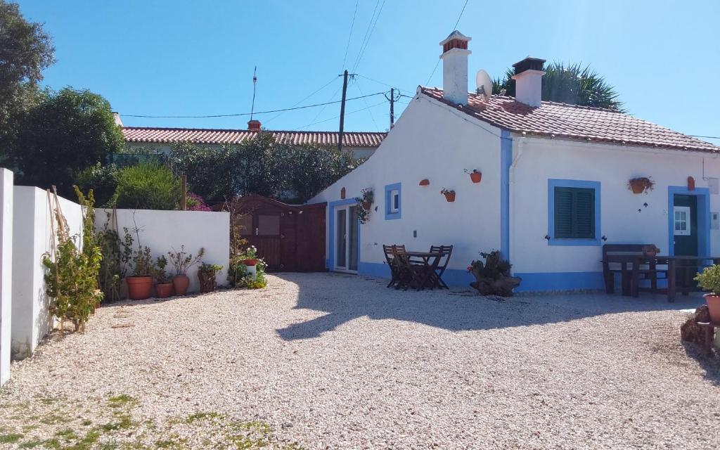 a small white house with a fence at Casa do Brejão 1 bedroom cottage in Odemira