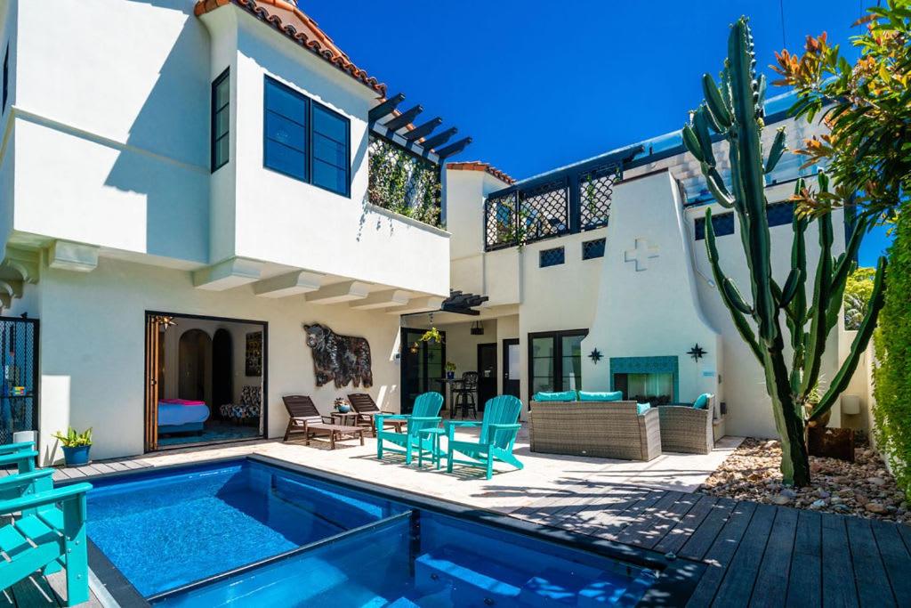 a villa with a swimming pool in front of a house at Spanish Villa with View Pool and Spa in San Diego