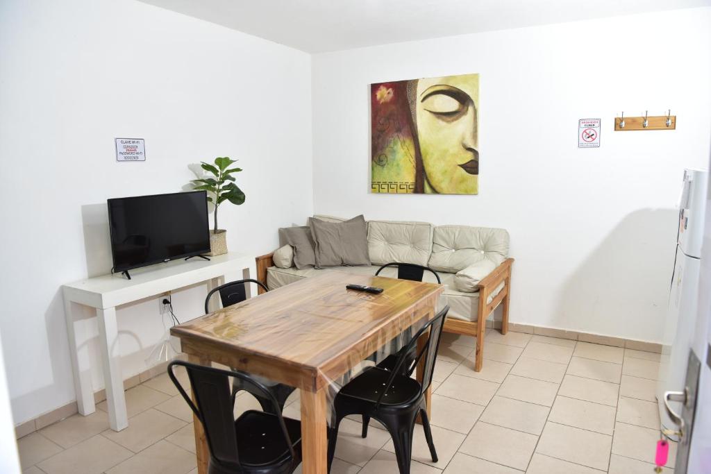 a living room with a table and a couch at Departamentos x dia Viedma 3 CON COCHERA in Viedma