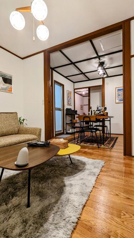 a living room with a couch and a table at Animal Art Apartment 201 in Ogikubo