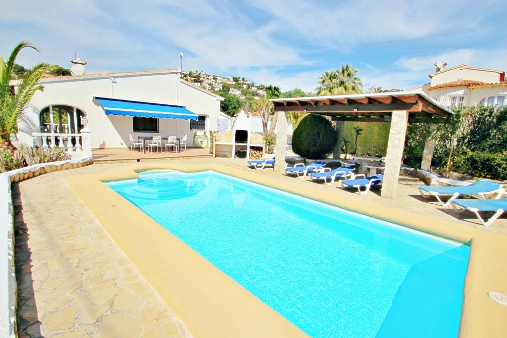 a villa with a swimming pool and a house at Kathrin - beautiful little house in pretty grounds with lovely views in Benissa in Benissa