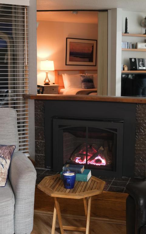 a living room with a fireplace and a bed at The Landmark Inn on Orcas Island in Eastsound