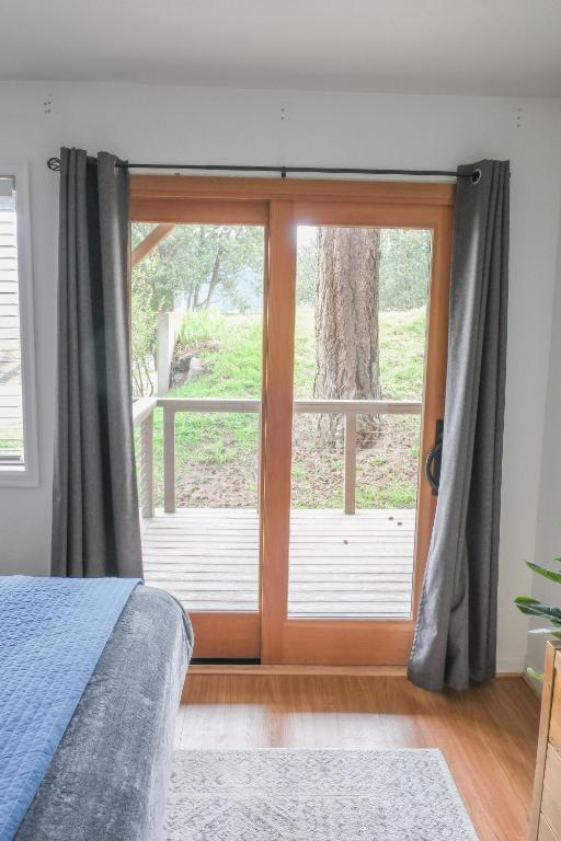 a bedroom with a large sliding glass door at The Landmark Inn on Orcas Island in Eastsound