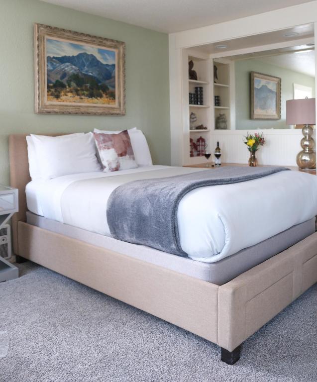 a large bed in a bedroom with a large bed frame at The Landmark Inn on Orcas Island in Eastsound