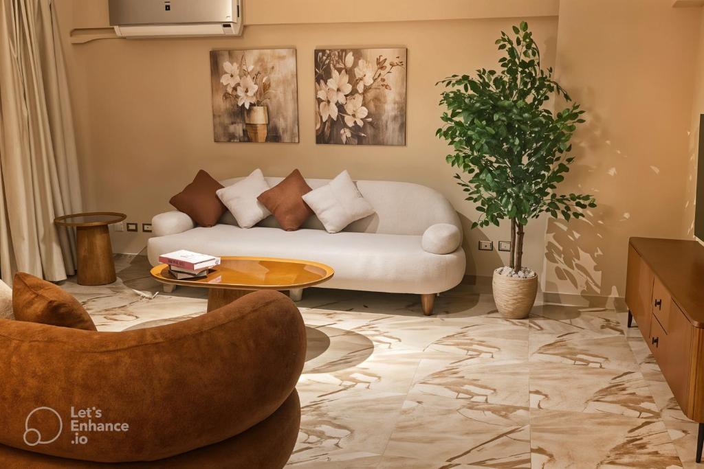 uma sala de estar com um sofá e uma mesa em Cairo Airport Haven Cozy and Convenient no Cairo