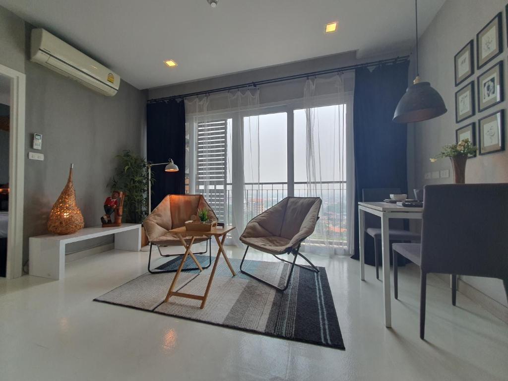 Una sala de estar con dos sillas y una mesa. en prio公寓, en Chiang Mai