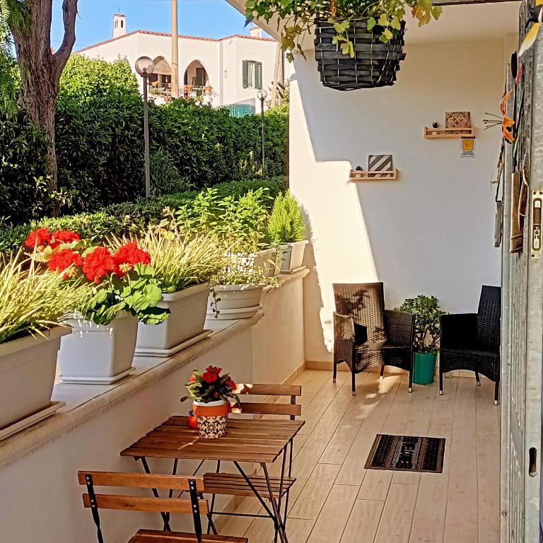 a patio with potted plants and a table and chairs at l'alba sullo jonio in Taranto