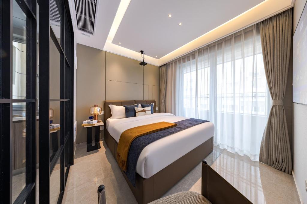 Postel nebo postele na pokoji v ubytování Xi Ke Executive Apartment - Shenzhen Futian Exhibition Center
