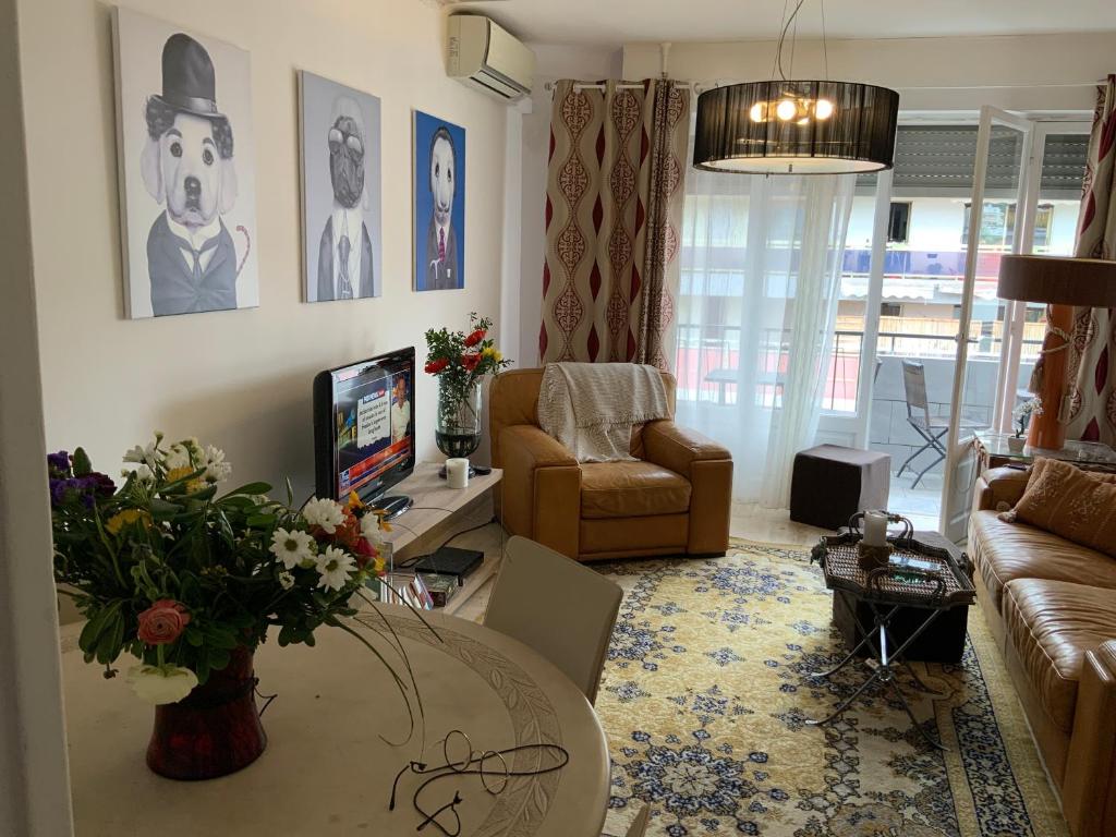a living room with a couch and a table at LUXURY APARTMENT between ANTIBS and CROISETTE in Cannes