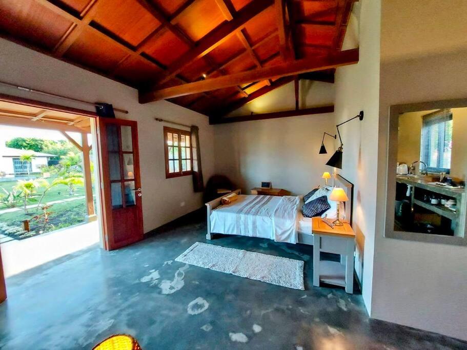 a bedroom with a bed and a desk with a bed sidx sidx sidx at Lakaz Kannell - Room 2 - Turtle Lodge, secluded outside bath & shower infinity pool in Cap Malheureux