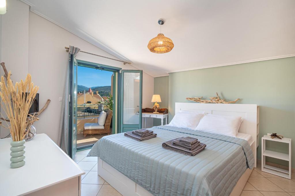 a bedroom with a bed with two towels on it at The Square Suites 2nd floor apartment in Argostoli