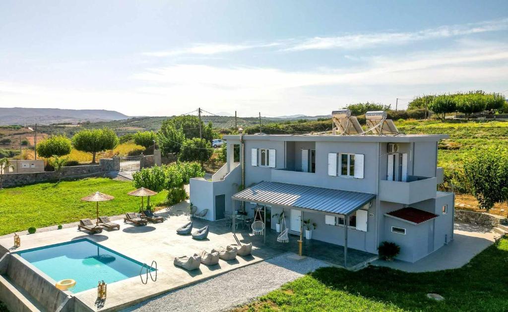 an aerial view of a villa with a swimming pool at Blue Harmony villa in Dhrámia