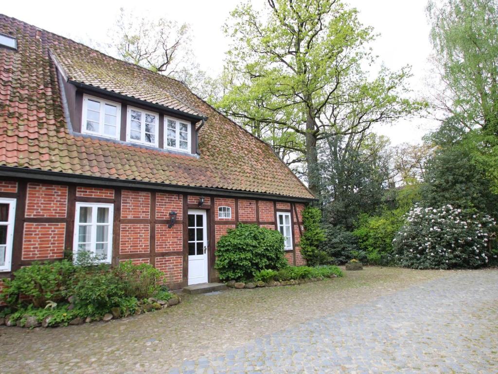 a red brick house with a white door at Beautiful holiday apartment in Dorfmark in Dorfmark