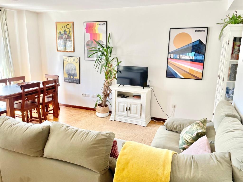 a living room with a couch and a table at La Casa de los Libros in Muros de Nalón