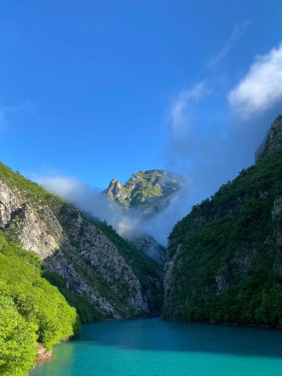 a view of a mountain lake in the mountains at Riverside Komani Lake in Koman