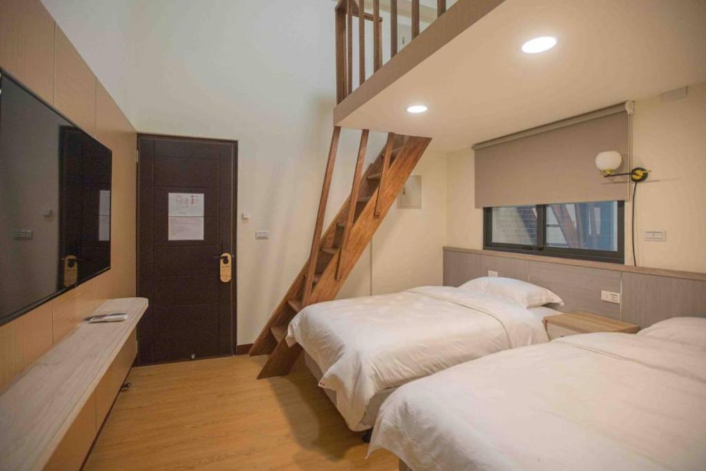 Postel nebo postele na pokoji v ubytování Xianwang Homestay