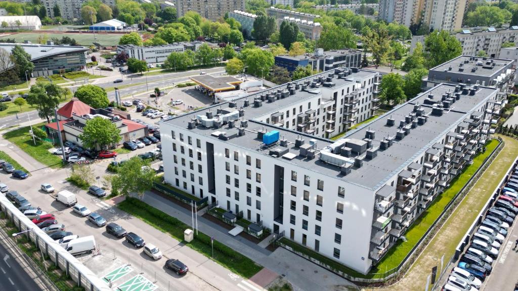 an aerial view of a large white building with a parking lot at BlueHouse Apartment Warsaw in Warsaw