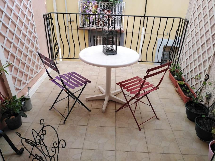 a white table and two chairs on a balcony at Maison de charme - proche toutes commodités in Marseillan