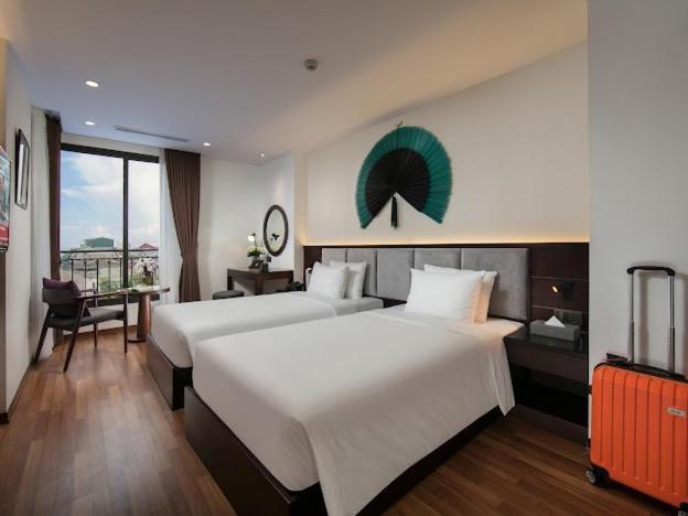 Posteľ alebo postele v izbe v ubytovaní Hanoi Fiesta Hotel & Spa