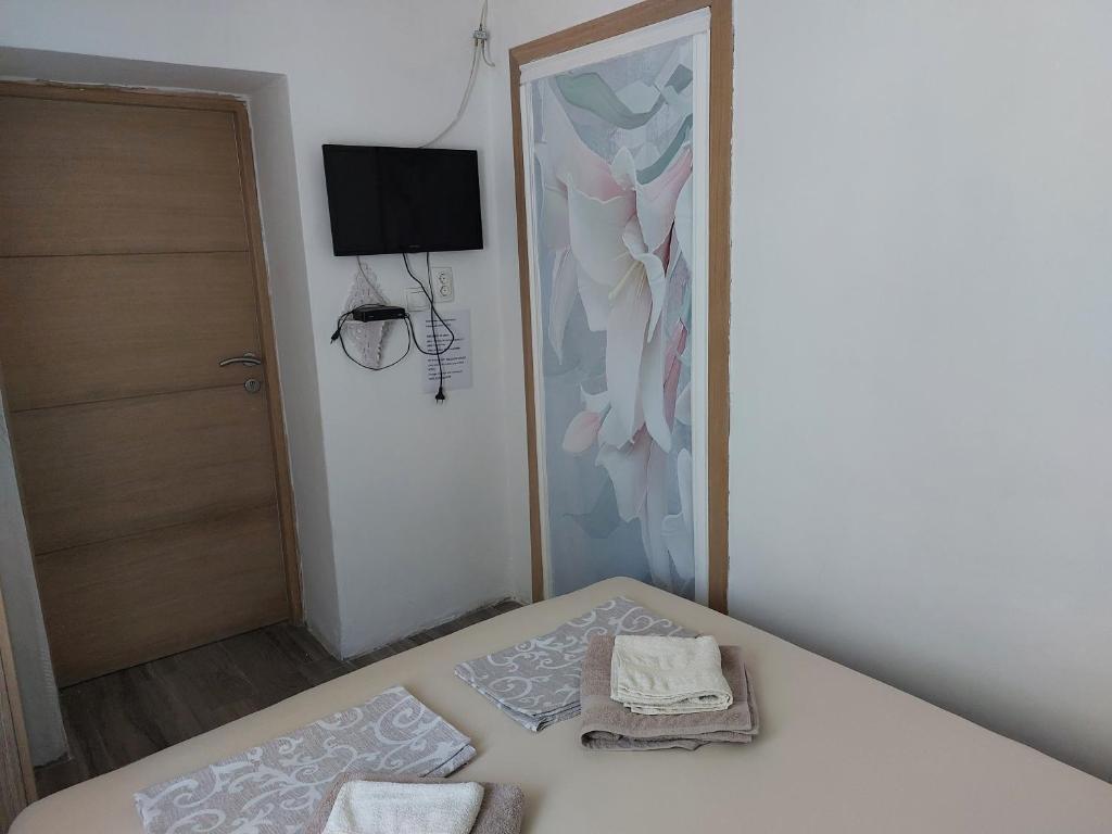 a bedroom with a bed with two towels on it at Vicky Apartments in Kotor