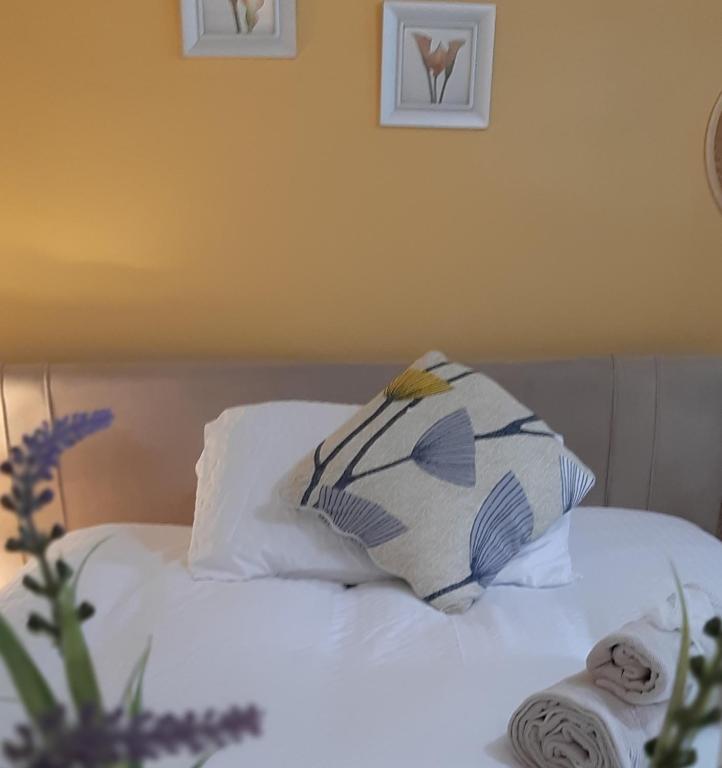a bed with two pillows and an umbrella on it at Beulah Serviced bedrooms in Aberdeen