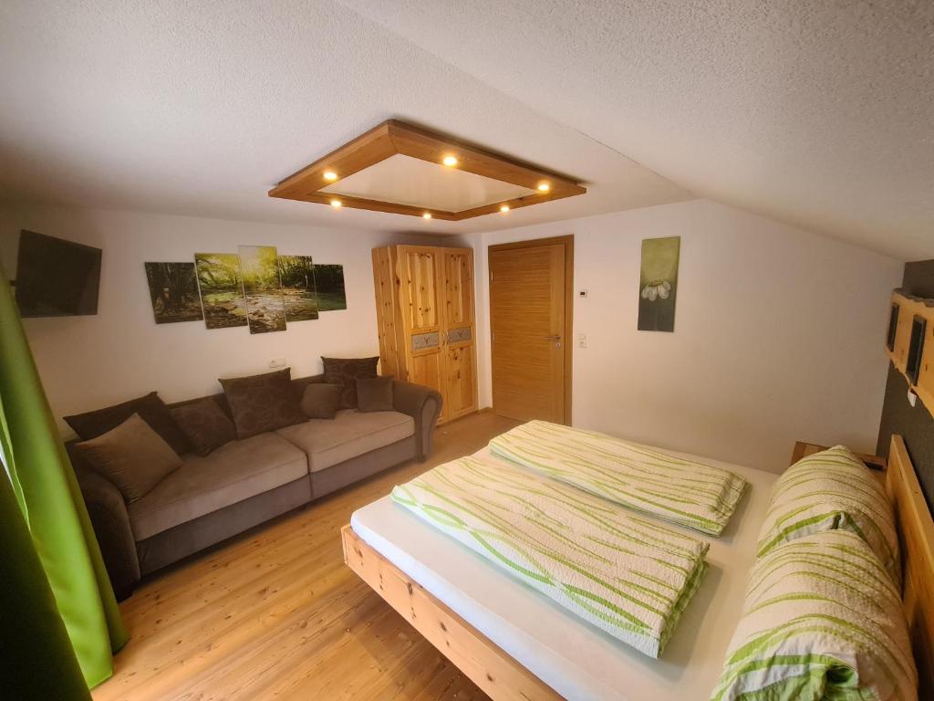 sala de estar con cama y sofá en Ferienwohnung Auenheim, en Innervillgraten