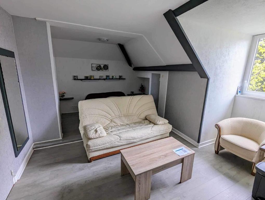 a living room with a couch and a coffee table at Chez madame loic in Fère-Champenoise