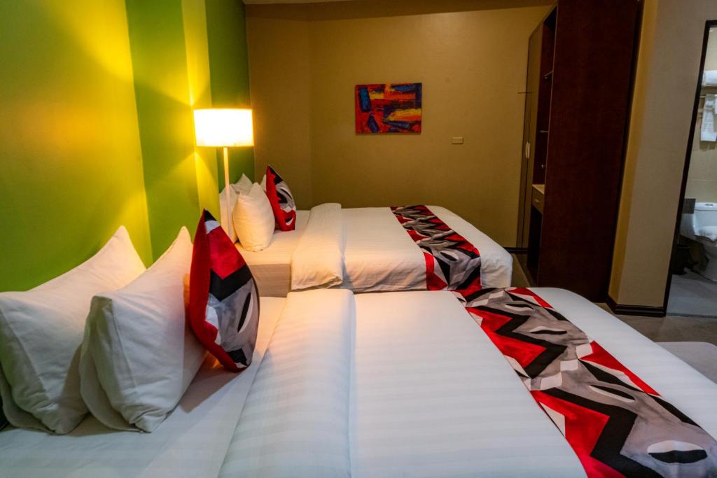 Postel nebo postele na pokoji v ubytování Kojo Hotels Cebu-Mandaue