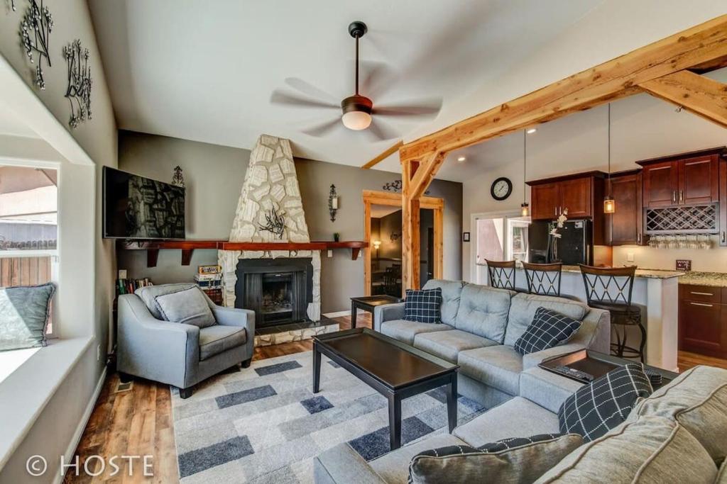 a living room with a couch and a fireplace at *H* NEW! 4BR Garden of the Gods Retreat in Colorado Springs