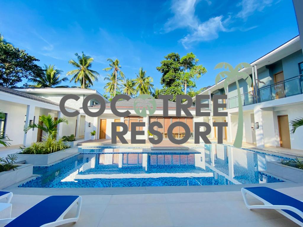 Cette villa dispose d'une piscine et d'un panneau indiquant la côte. dans l'établissement Cocotree Resort, à Panglao