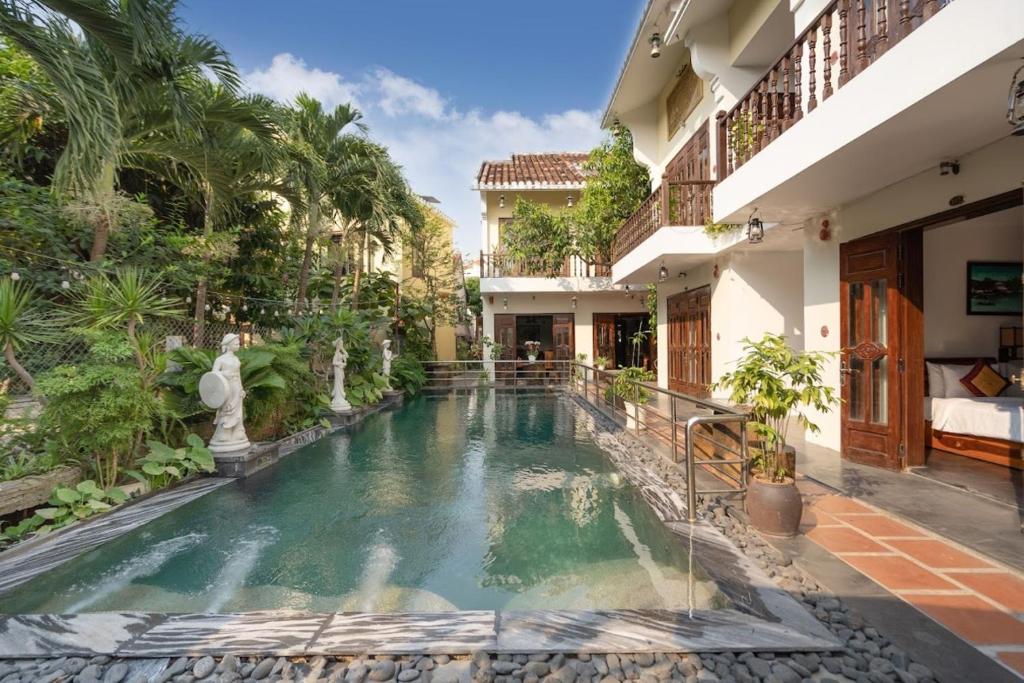 a swimming pool in the middle of a house at Truc Huy Villa in Hoi An