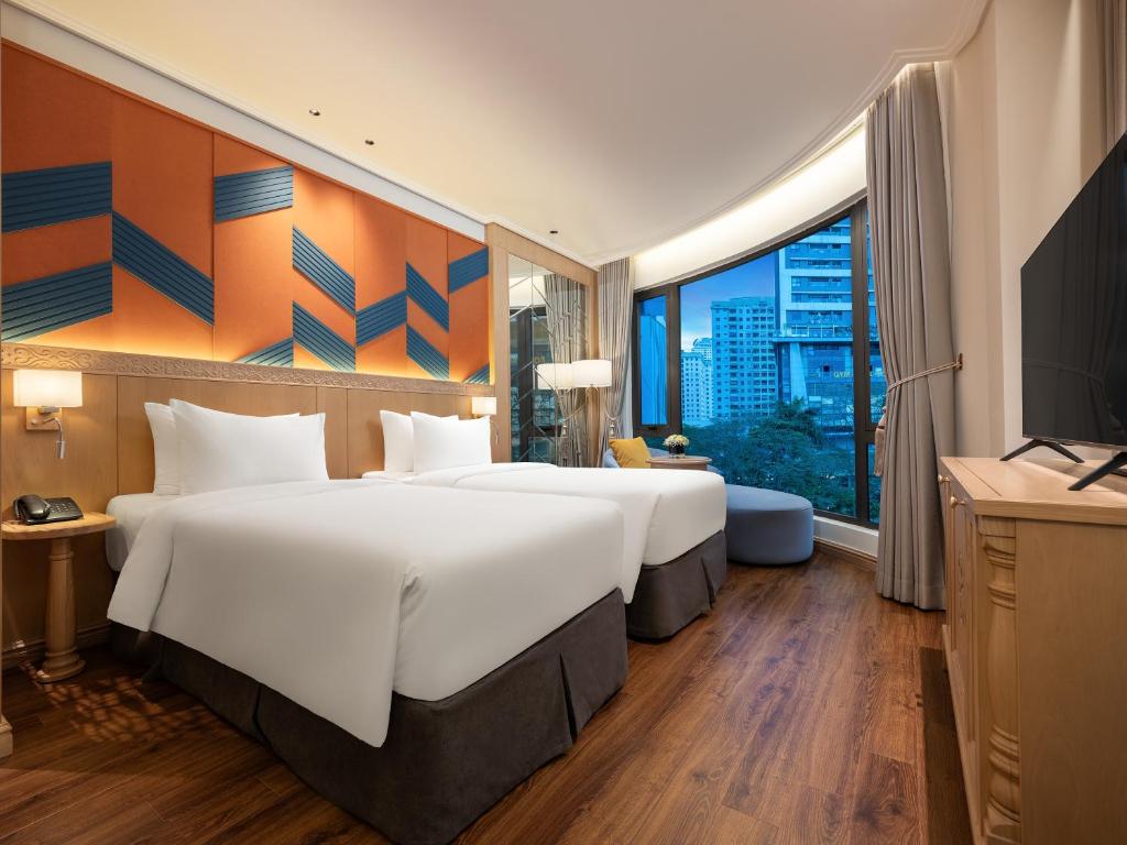 Postel nebo postele na pokoji v ubytování Saigon Aroma Hotel