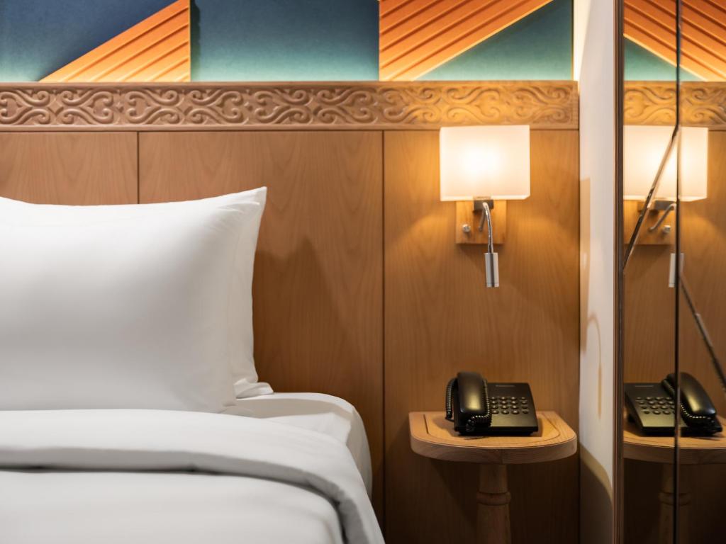 Postel nebo postele na pokoji v ubytování Saigon Aroma Hotel