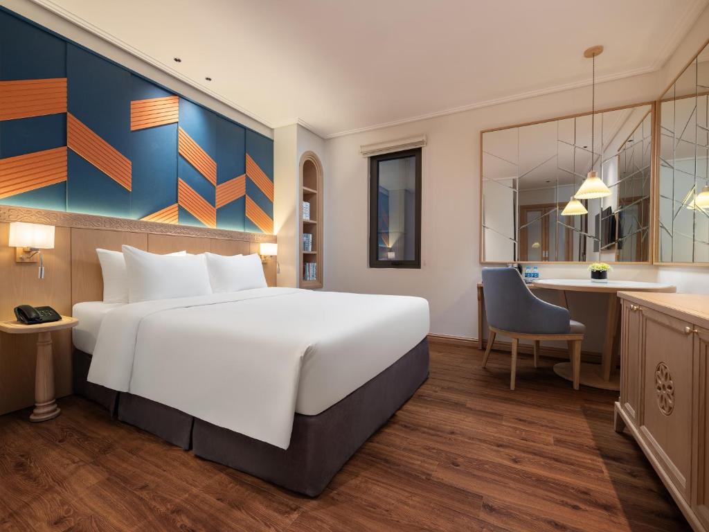 Postel nebo postele na pokoji v ubytování Saigon Aroma Hotel
