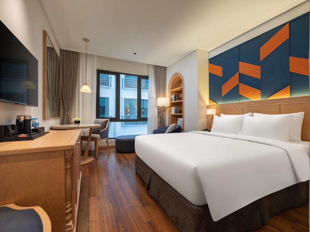 Postel nebo postele na pokoji v ubytování Saigon Aroma Hotel