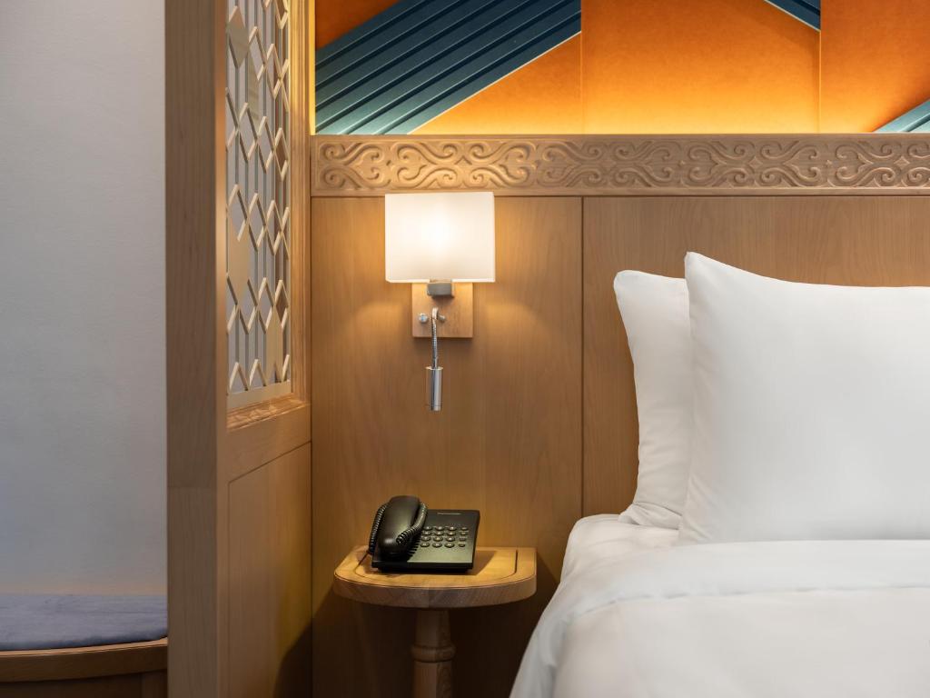 Postel nebo postele na pokoji v ubytování Saigon Aroma Hotel