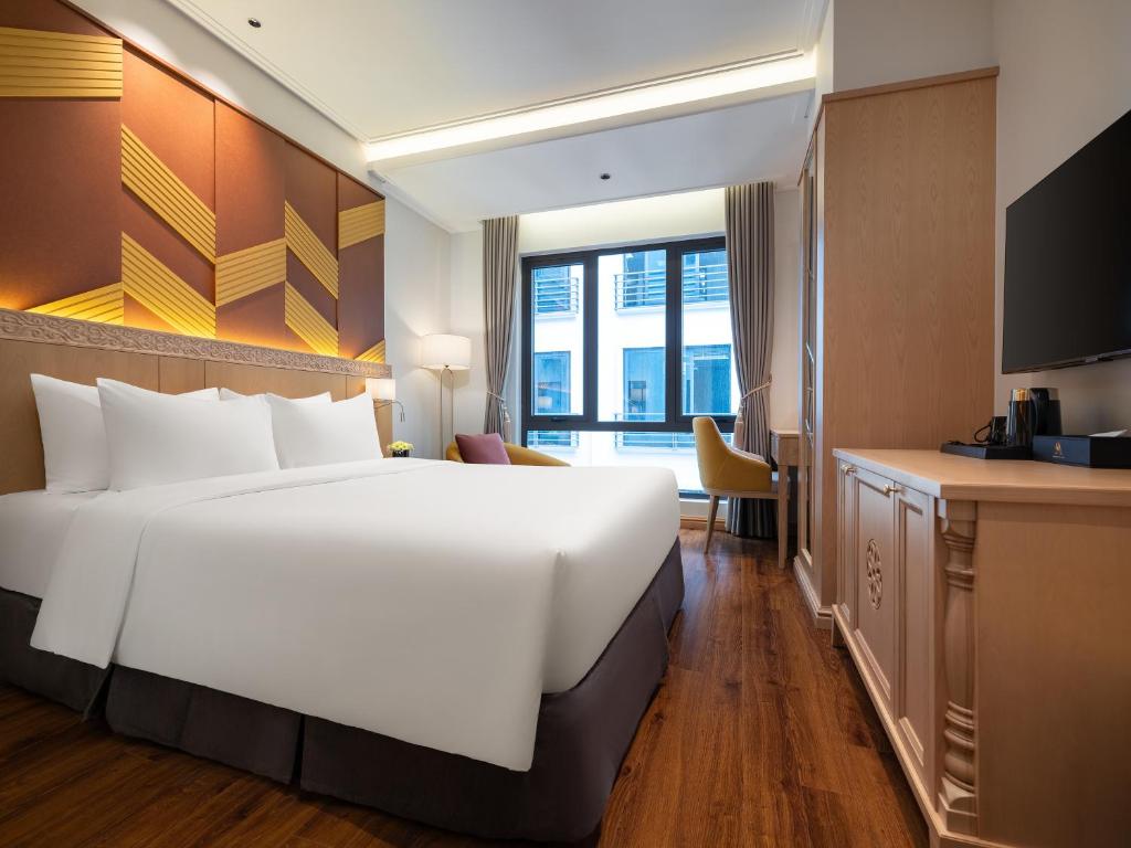 Postel nebo postele na pokoji v ubytování Saigon Aroma Hotel