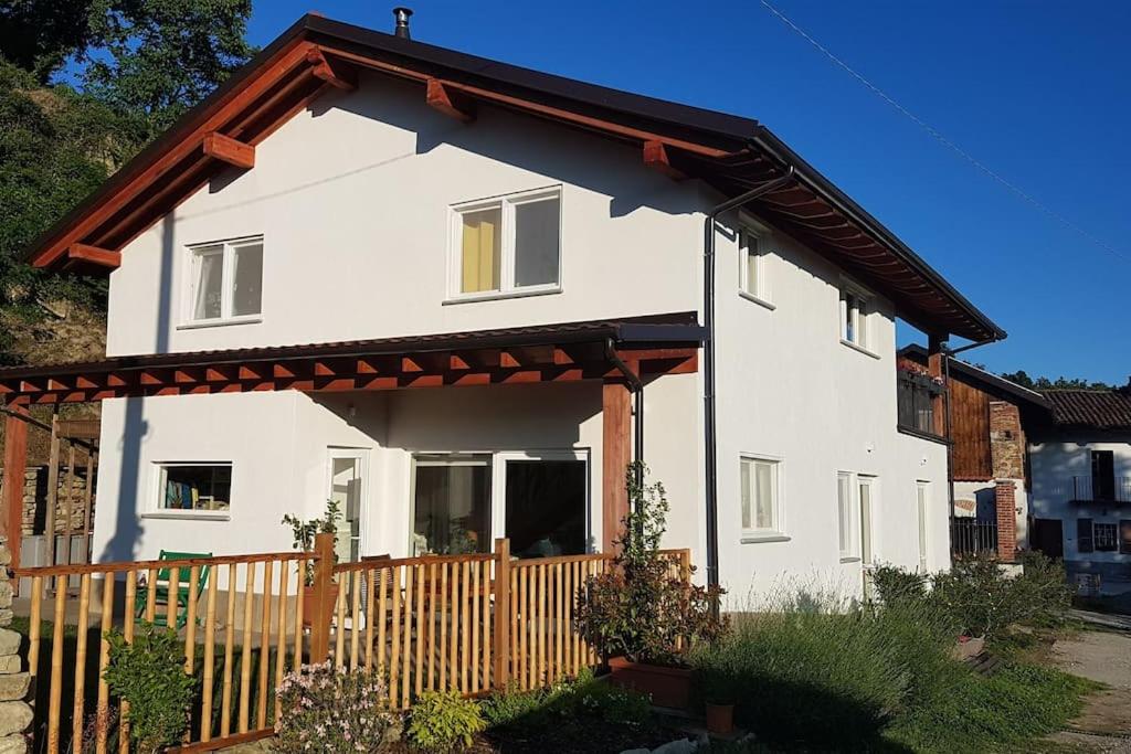 a white house with a wooden fence at Casa Vacanza Mattirolo - Castagneto Po in Castagneto Po