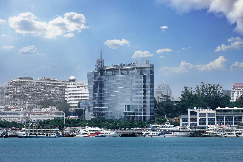 a view of a city with boats in the water at Hotel Indigo Xiamen Harbour, an IHG Hotel in Xiamen