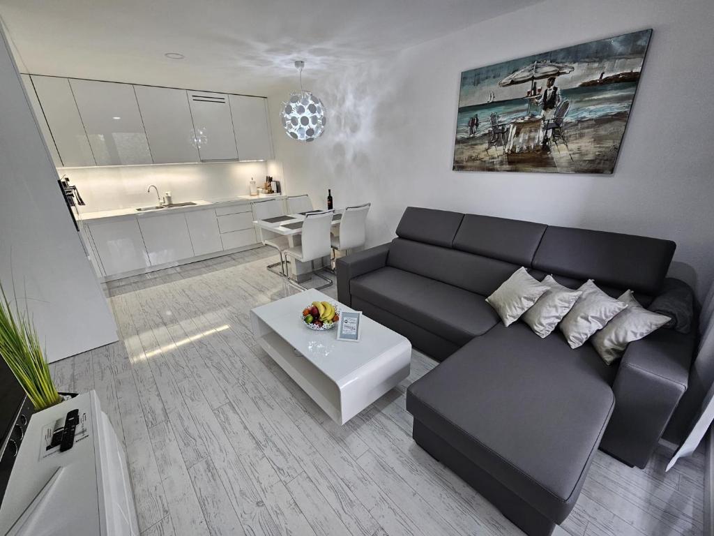 a living room with a black couch and a table at Apartmány Urban in Poprad