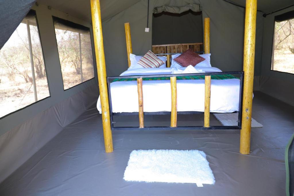 a bedroom with a bunk bed in a tent at Emunyan maasai Mara camp in Sekenani