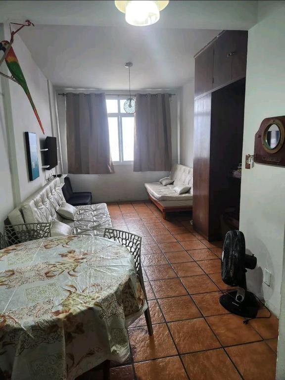 a living room with a table and a couch at Studio em Santos Kitnet in Santos