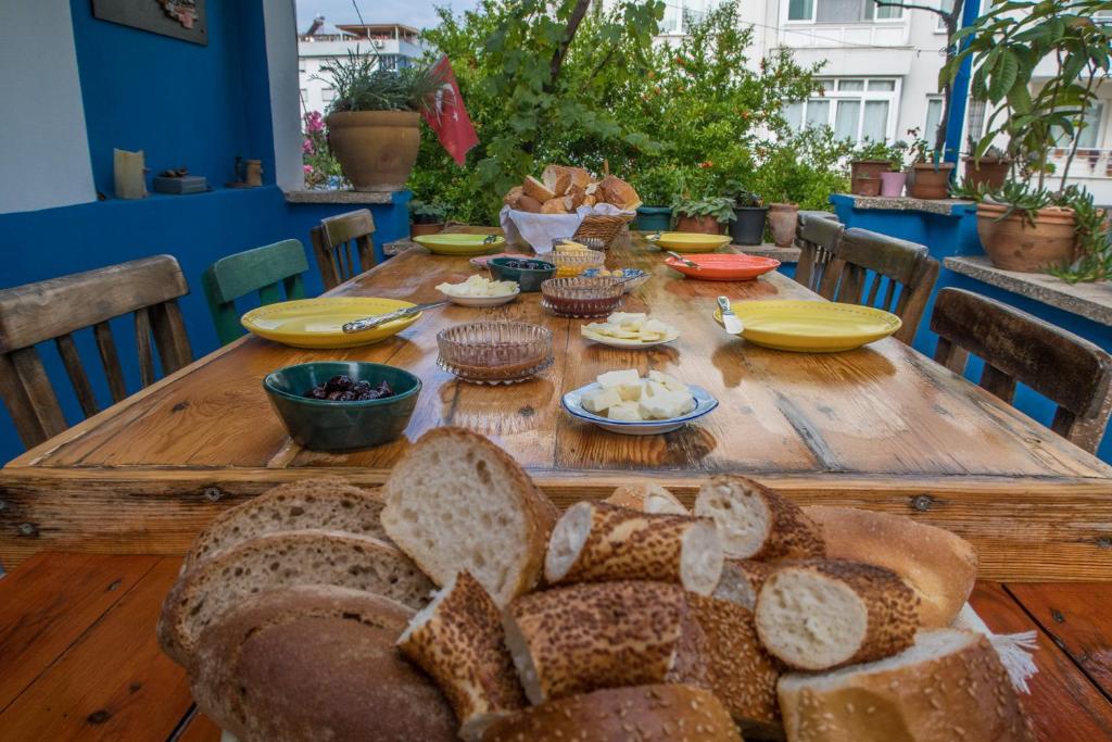 una mesa de madera con rebanadas de pan. en Ecer Pansiyon, en Kusadasi