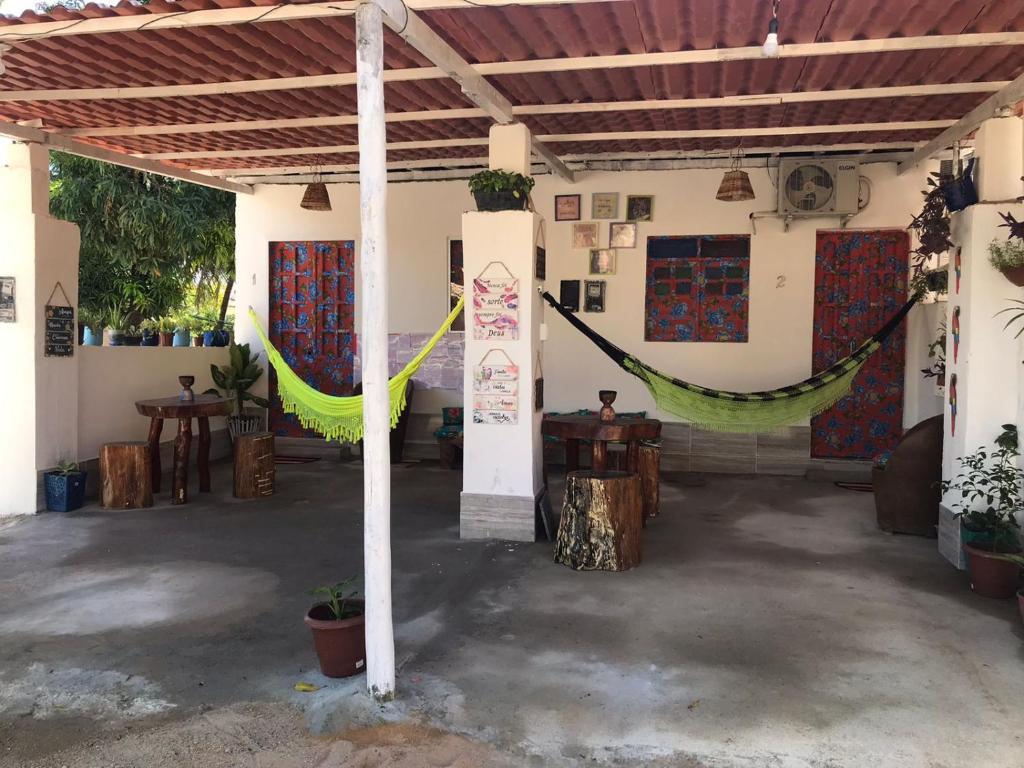 una habitación con una hamaca colgada de un edificio en Cantinho da mery 1 en Maragogi