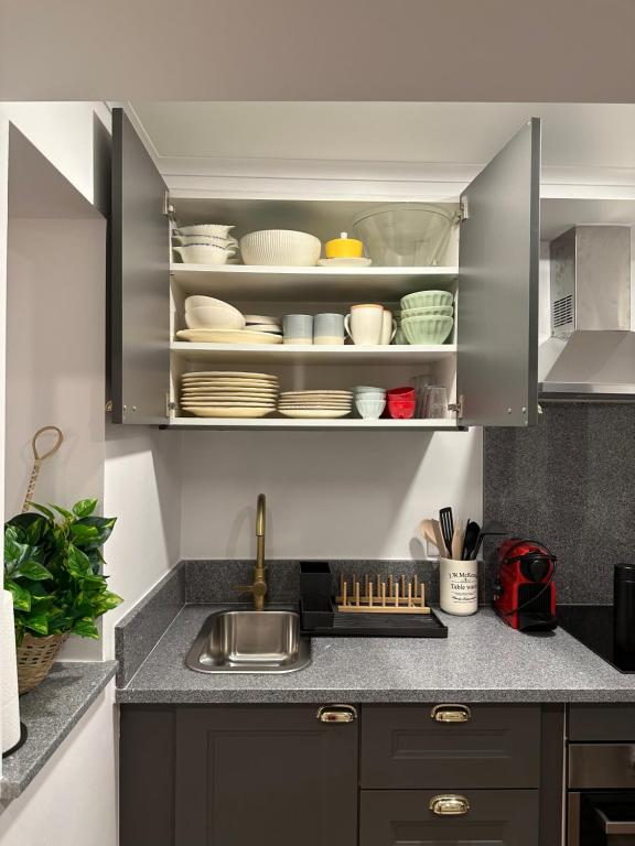 a kitchen with a sink and a shelf with dishes at Casa da Boavista in Arraiolos