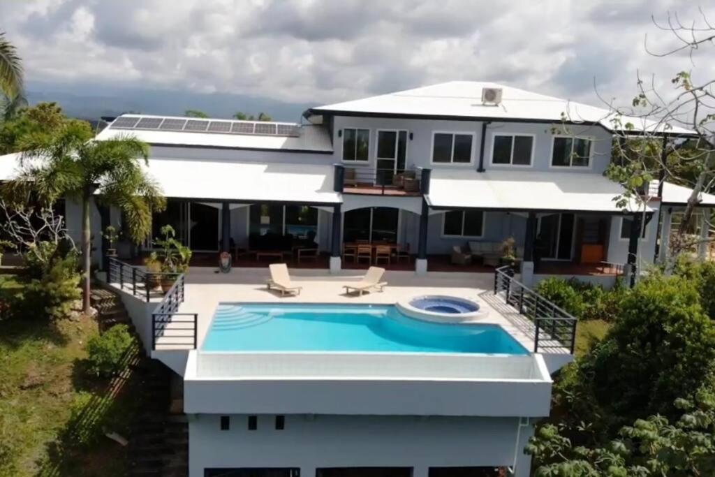 a house with a swimming pool in front of it at Luxury Villa with Separate Guest house and 360view in Quepos