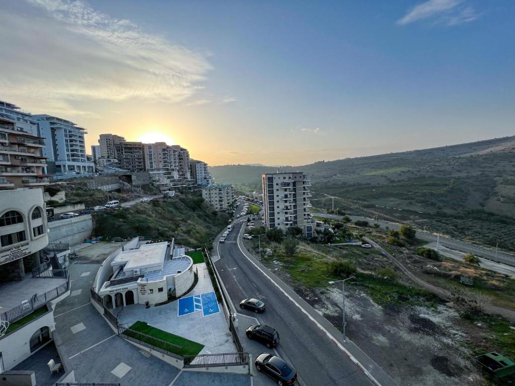 an aerial view of a city with a road and buildings at פנטהאוז השומר in Tiberias