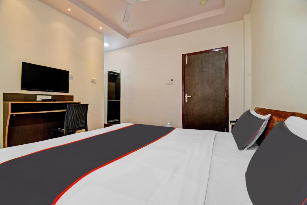 Un pat sau paturi într-o cameră la Collection O The Grand Megha Resort